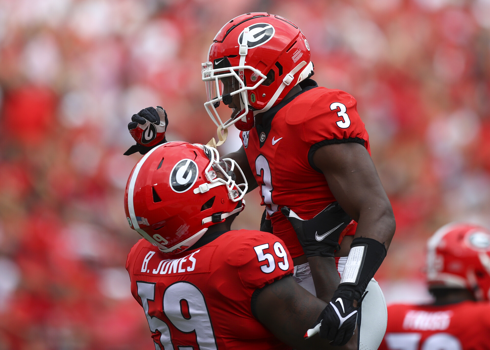 Zamir White #3 of the Georgia Bulldogs reacts with Broderick Jones #59 after a touchdown in the first half against the Arkansas Razorbacks at Sanford Stadium on October 2, 2021 in Athens, Georgia.