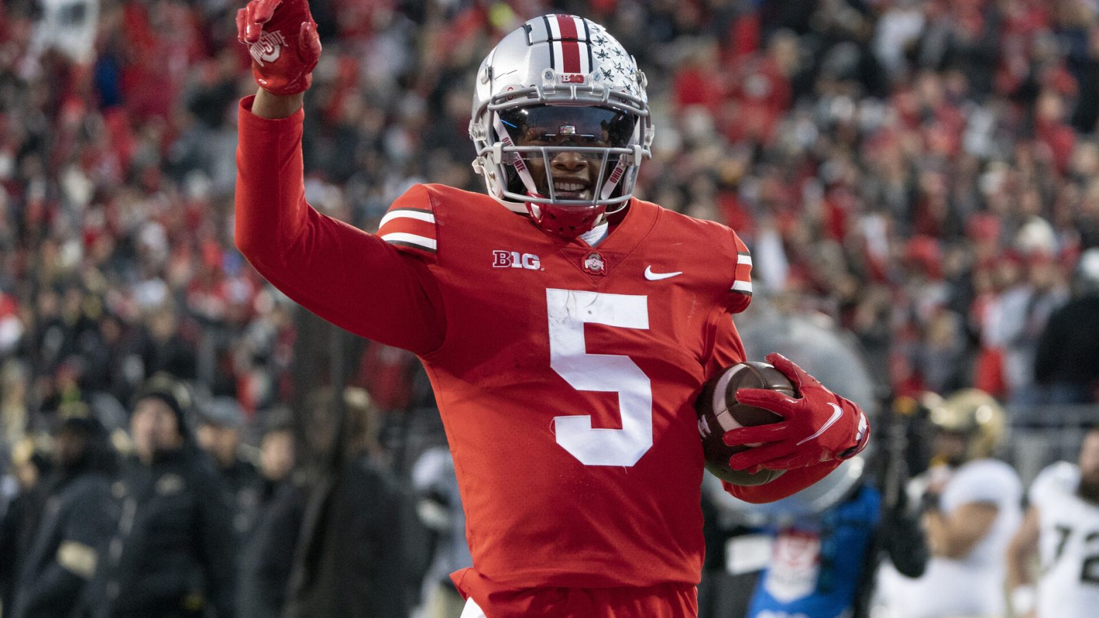 Ohio State Buckeyes wide receiver Garrett Wilson #5 celebrating as he runs with the ball during the game between the Ohio State Buckeyes and the Purdue Boilermakers at Ohio Stadium in Columbus, Ohio on November 13, 2021.