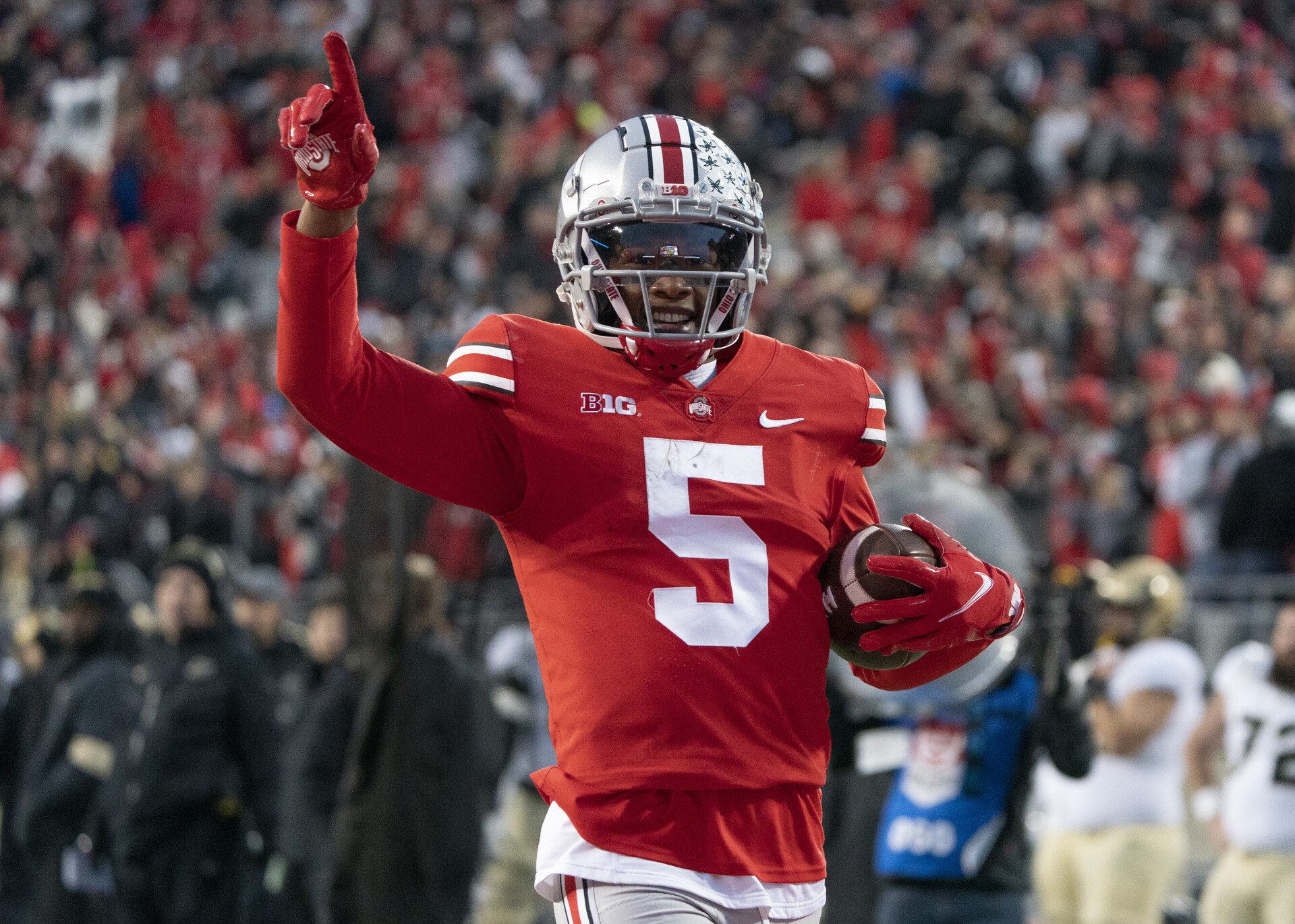 Ohio State Buckeyes wide receiver Garrett Wilson #5 celebrating as he runs with the ball during the game between the Ohio State Buckeyes and the Purdue Boilermakers at Ohio Stadium in Columbus, Ohio on November 13, 2021.