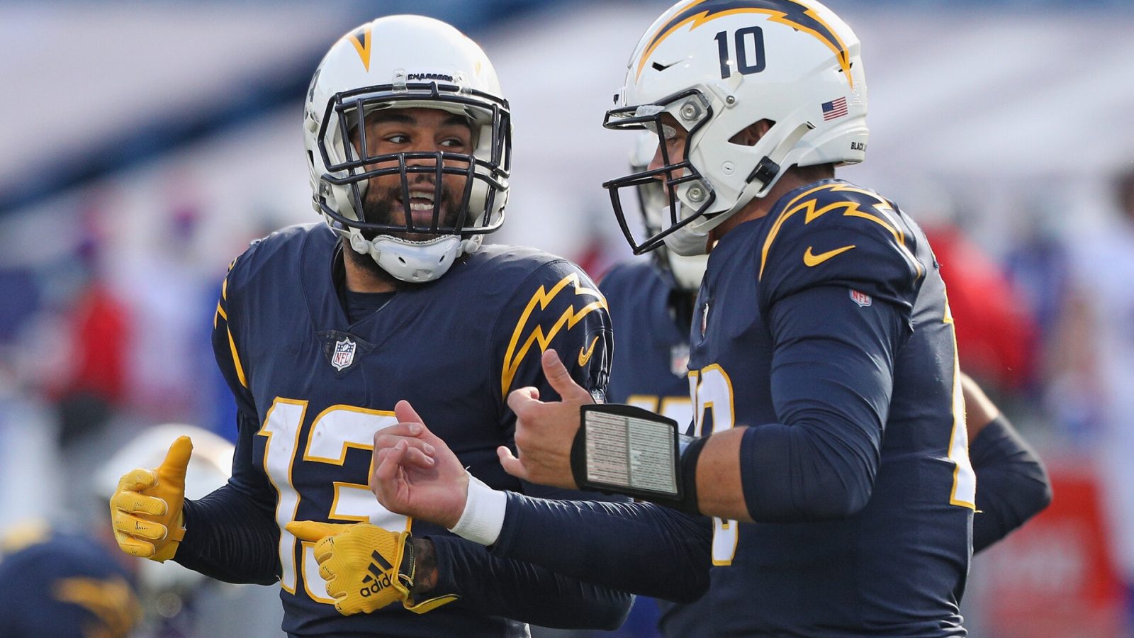 Keenan Allen #13 and Justin Herbert #10 of the Los Angeles Chargers celebrate a first quarter touchdown against the Buffalo Bills at Bills Stadium on November 29, 2020 in Orchard Park, New York.
