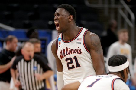 Kofi Cockburn #21 of the Illinois Fighting Illini reacts to a basket against the Loyola Chicago Ramblers during the first half in the second round game of the 2021 NCAA Men's Basketball Tournament at Bankers Life Fieldhouse on March 21, 2021 in Indianapolis, Indiana.