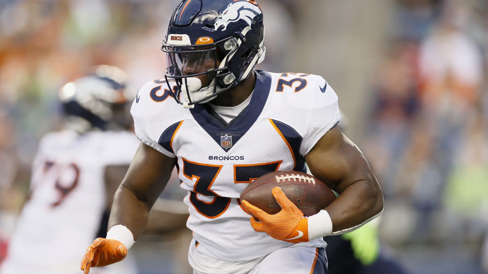 Running back Javonte Williams #33 of the Denver Broncos carries the ball in the first half during an NFL preseason game against the Seattle Seahawks at Lumen Field on August 21, 2021 in Seattle, Washington. The Denver Broncos beat the Seattle Seahawks 30-3.
