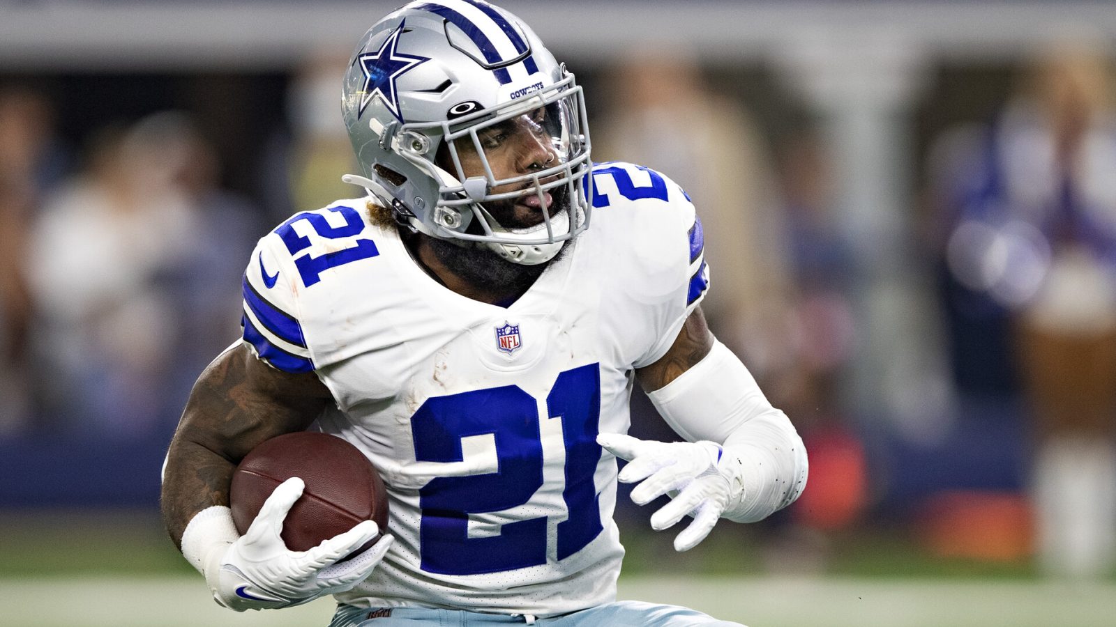 Ezekiel Elliott #21 of the Dallas Cowboys runs the ball during a game against the New York Giants at AT&T Stadium on October 10, 2021 in Arlington, Texas. The Cowboys defeated the Giants 44-20.