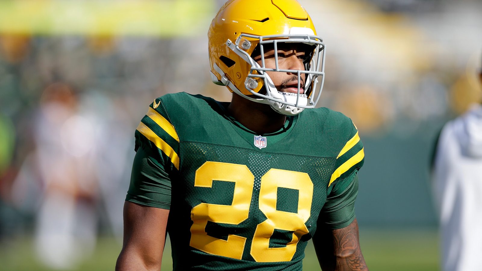 A.J. Dillon #28 of the Green Bay Packers warms up before the game against the Washington Football Team at Lambeau Field on October 24, 2021 in Green Bay, Wisconsin. Green Bay defeated Washington 24-10.