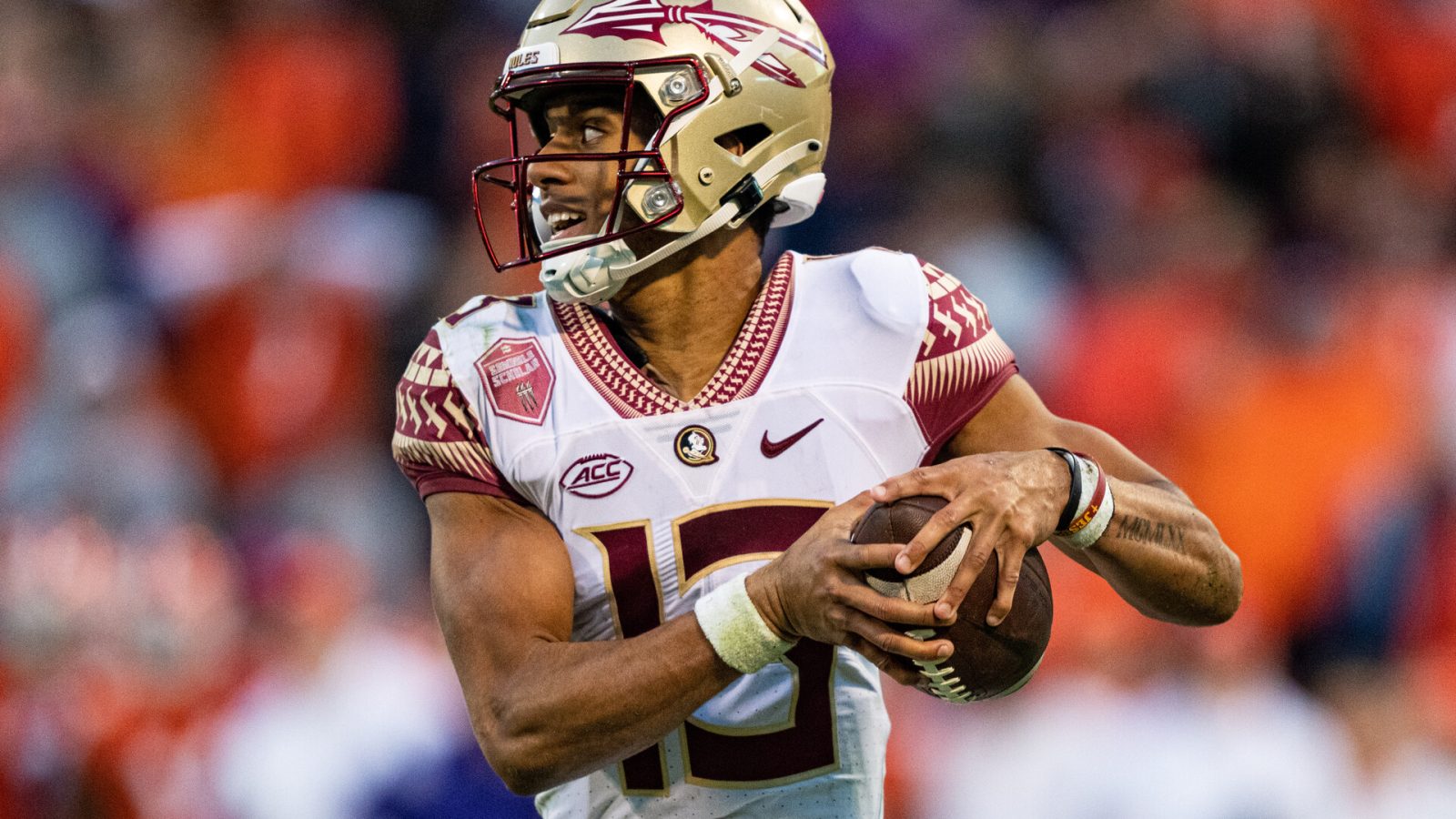 Quarterback Jordan Travis #13 of the Florida State Seminoles runs with the ball against the Clemson Tigers during their game at Clemson Memorial Stadium on October 30, 2021 in Clemson, South Carolina.