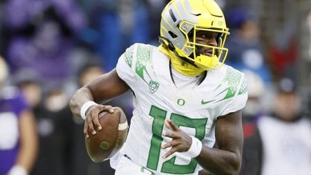 Quarterback Anthony Brown #13 of the Oregon Ducks carries the ball against the Washington Huskies at Husky Stadium on November 06, 2021 in Seattle, Washington.