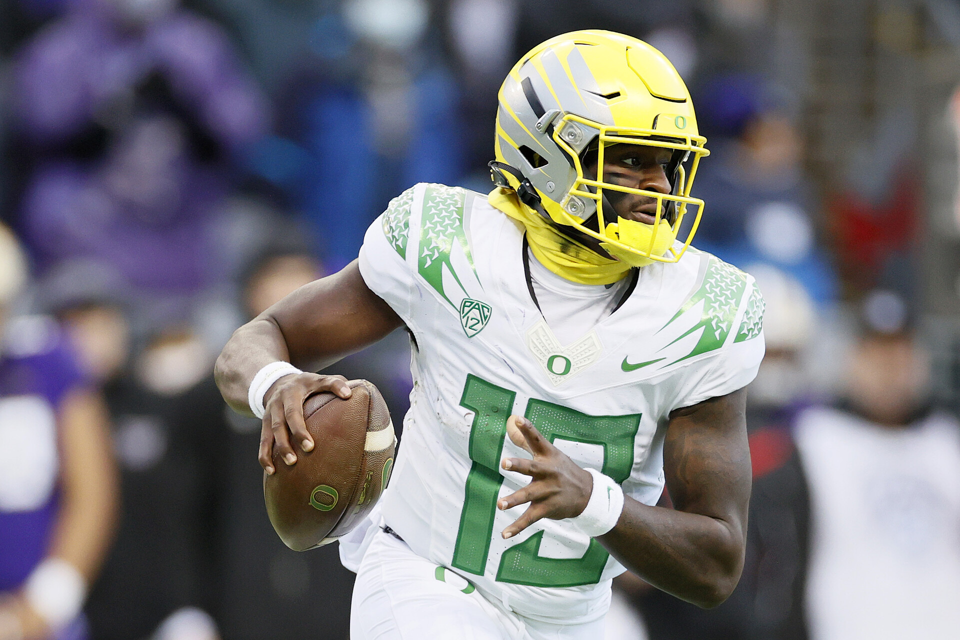 Quarterback Anthony Brown #13 of the Oregon Ducks carries the ball against the Washington Huskies at Husky Stadium on November 06, 2021 in Seattle, Washington.