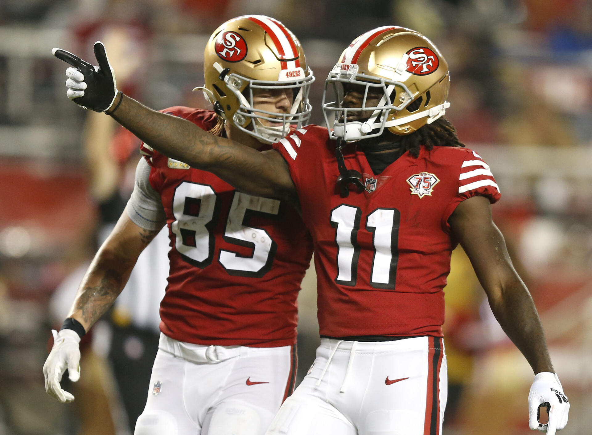 Brandon Aiyuk #11 celebrates with teammate George Kittle #85 of the San Francisco 49ers after getting a touchdown in the second half of the game against the Los Angeles Rams at Levi's Stadium on November 15, 2021 in Santa Clara, California.