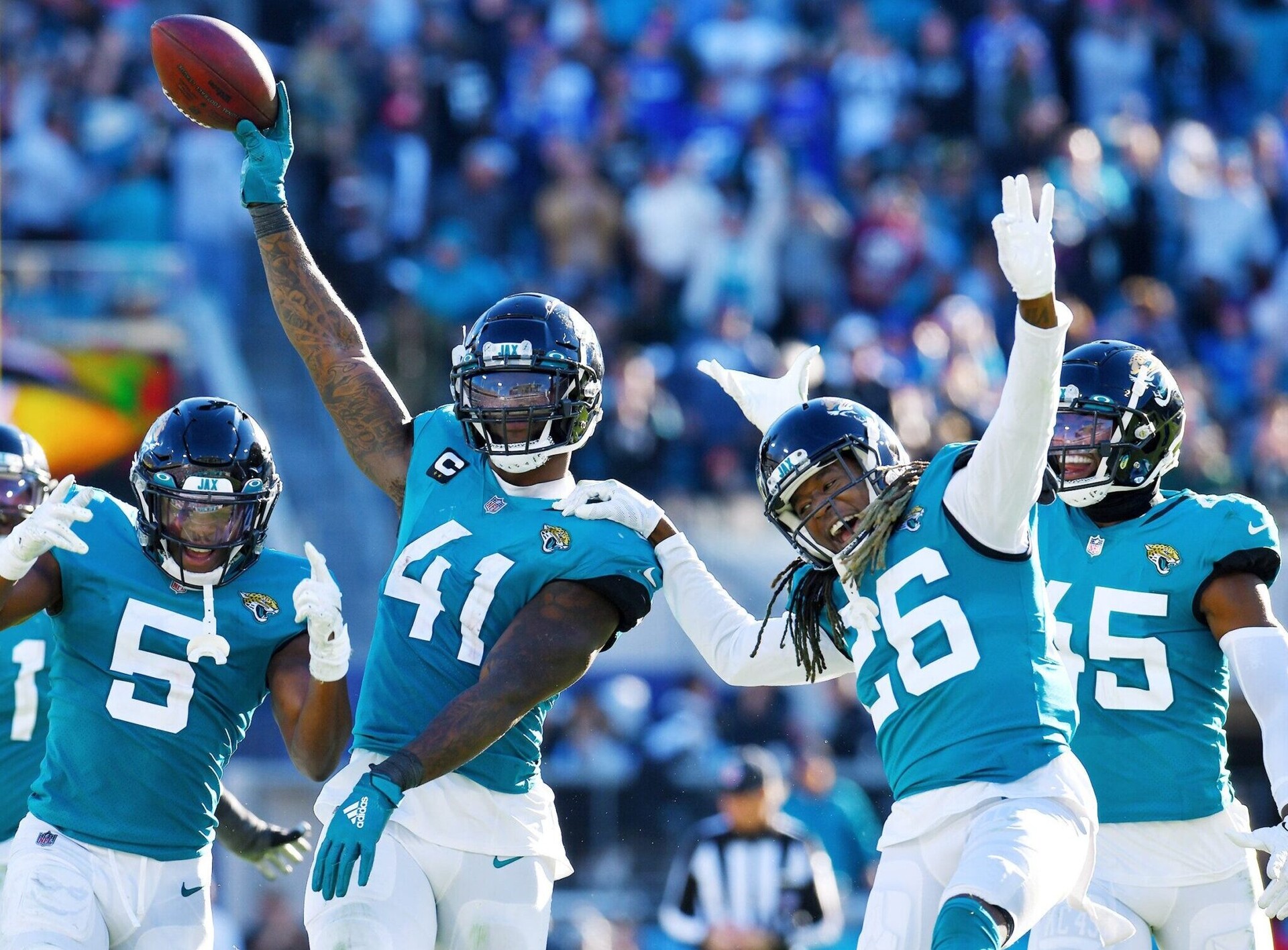 Jacksonville Jaguars linebacker Josh Allen (41), safety Rudy Ford (5) and cornerback Shaquill Griffin (26) and other teammates celebrate after Allen's recovery of a Buffalo fumble