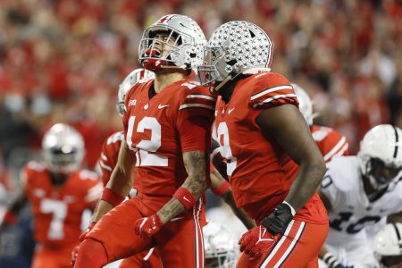 Ohio State Buckeyes safety Lathan Ransom celebrates a sack of Penn State Nittany Lions quarterback Sean Clifford with defensive end Zach Harrison in a game against Penn State