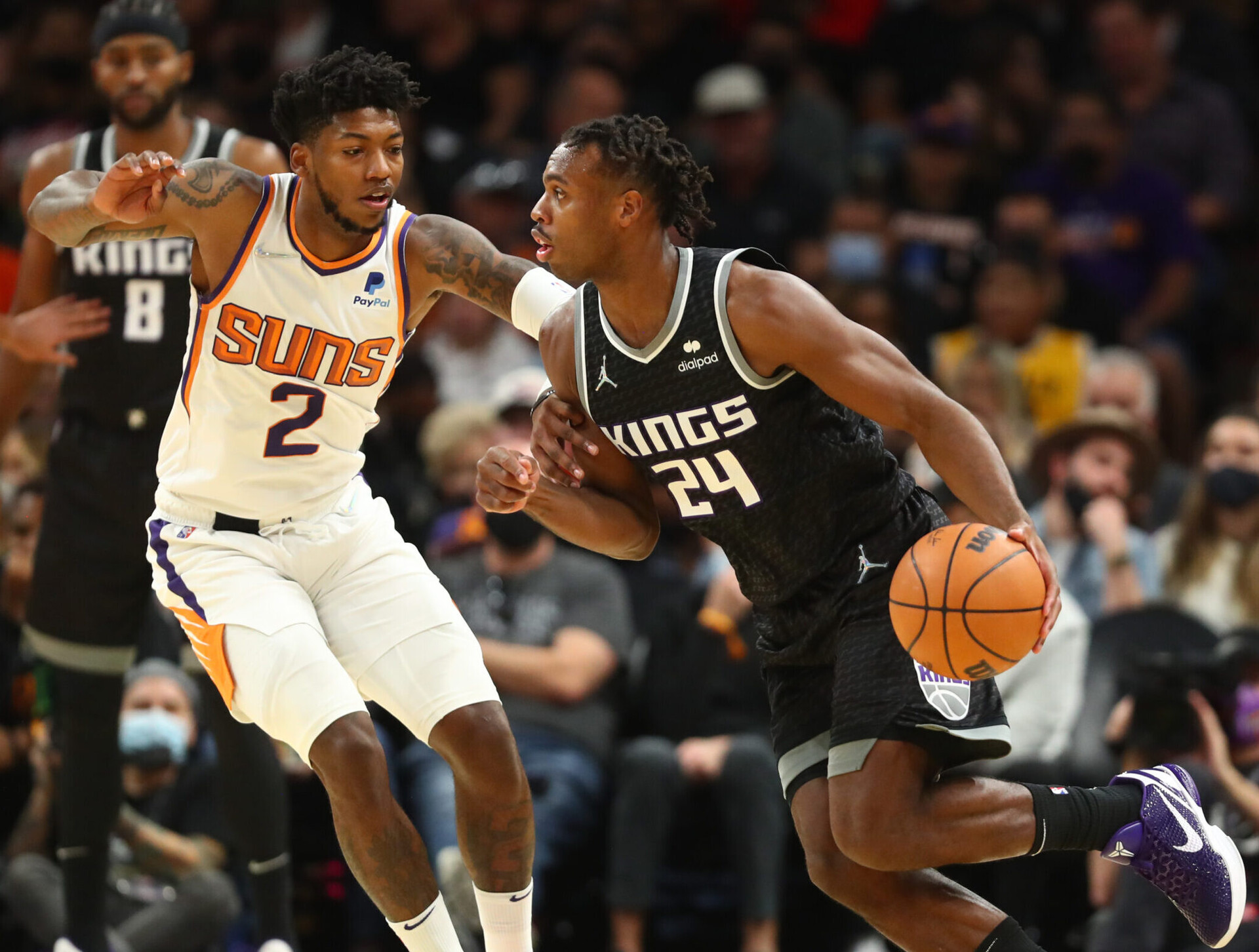 Sacramento Kings guard Buddy Hield dribbles against Phoenix Suns guard Elfrid Payton in a game