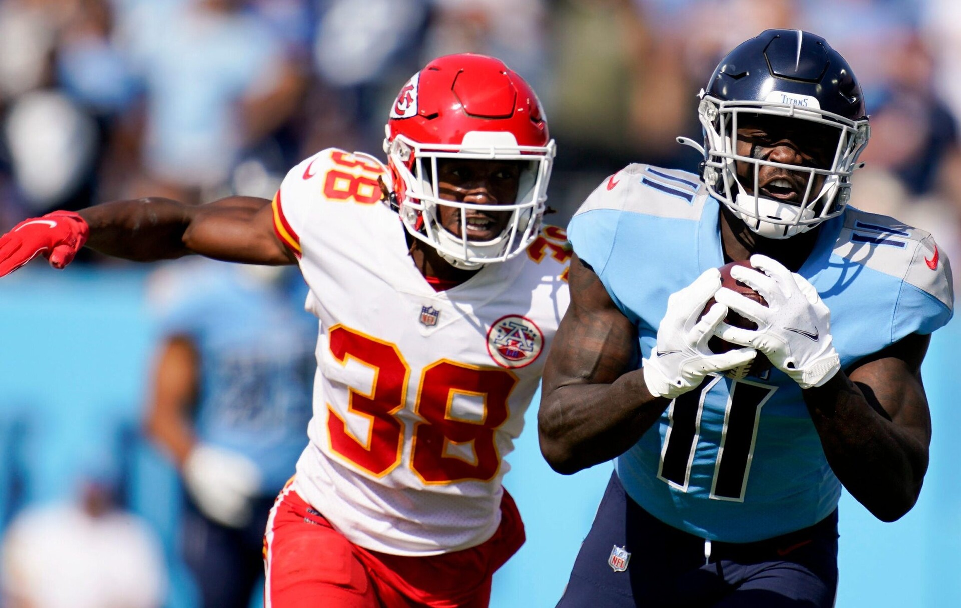 Tennessee Titans wide receiver A.J. Brown (11) pulls in a catch while pursued by Kansas City Chiefs cornerback L'Jarius Sneed (38)