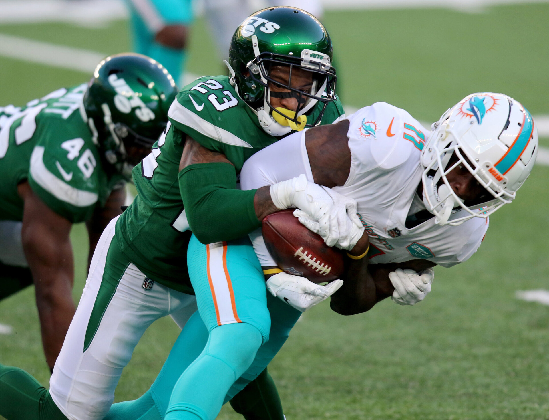 New York Jets cornerback Arthur Maulet (left) tackles Miami Dolphins wide receiver DeVante Parker (right)