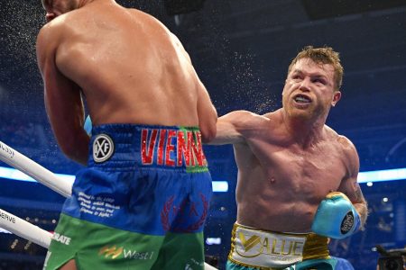 Canelo Alvarez connects with a punch against Billy Joe Saunders during a super middleweight boxing title fight