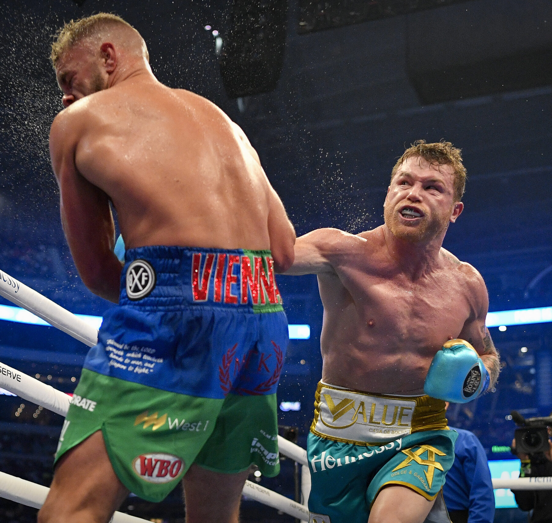 Canelo Alvarez connects with a punch against Billy Joe Saunders during a super middleweight boxing title fight