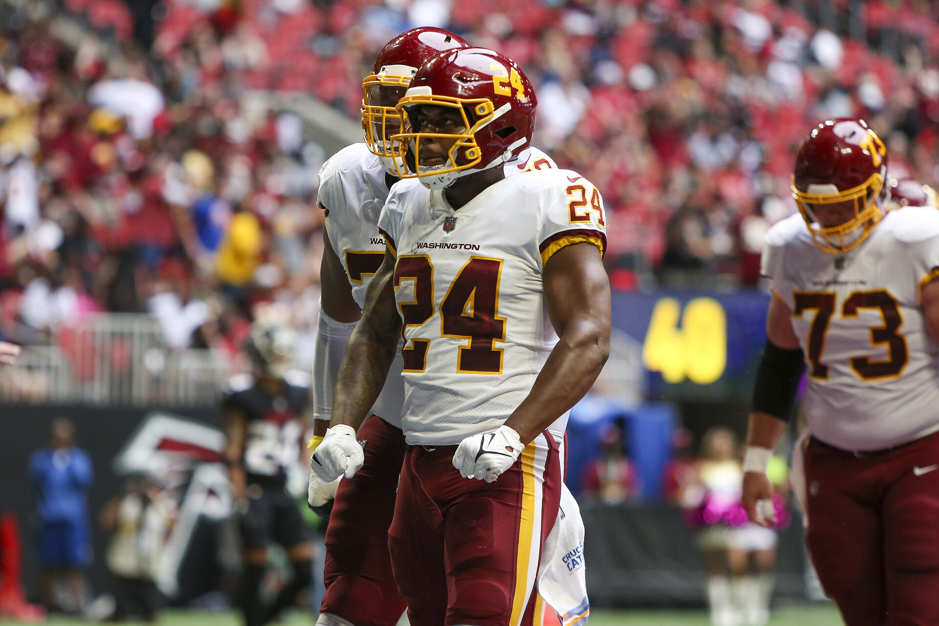 Washington Football Team running back Antonio Gibson (24) celebrates after a touchdown against the Atlanta Falcons in the second quarter at Mercedes-Benz Stadium.