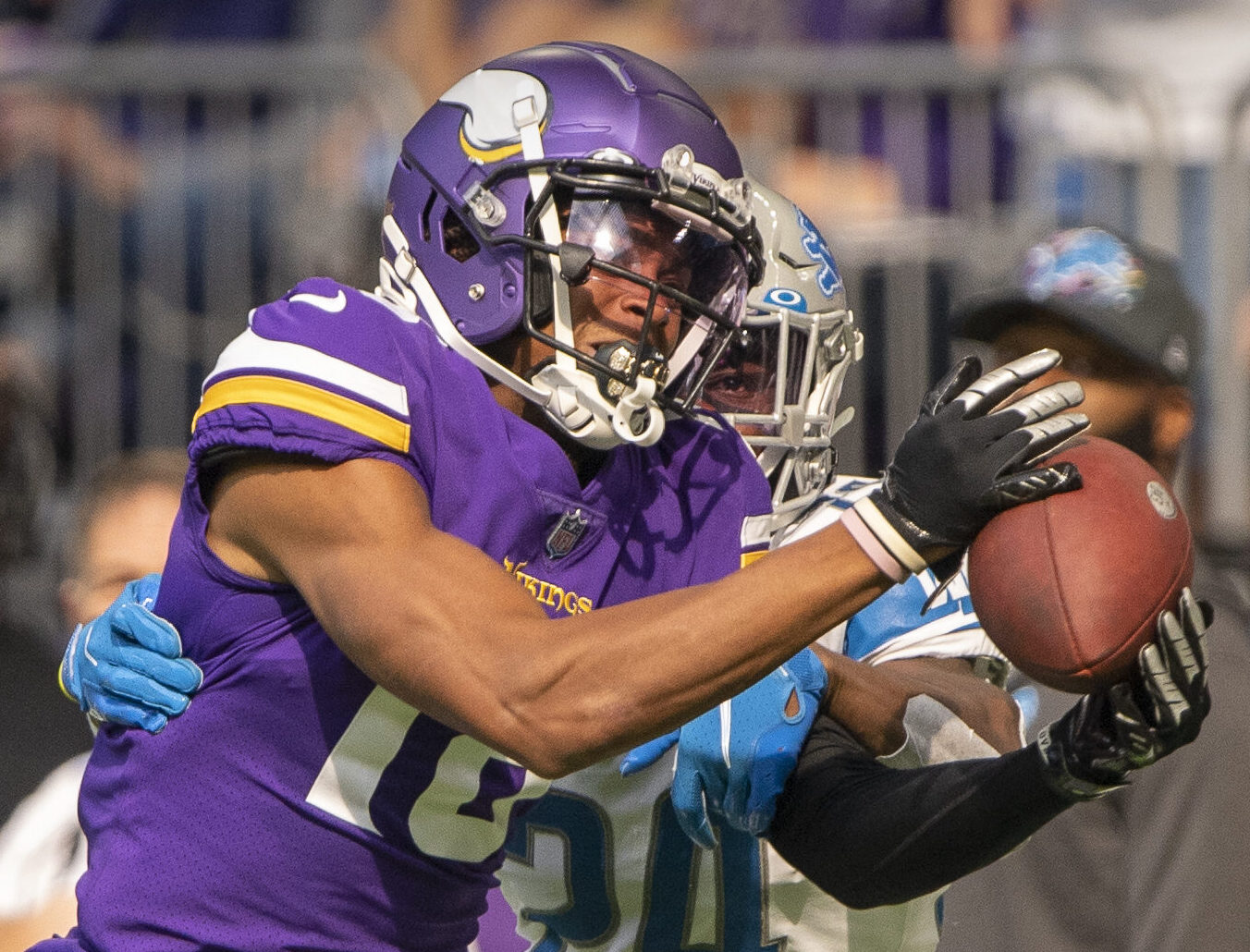 Minnesota Vikings wide receiver Justin Jefferson catches a pass for a first down as Detroit Lions cornerback Amani Oruwariye defends