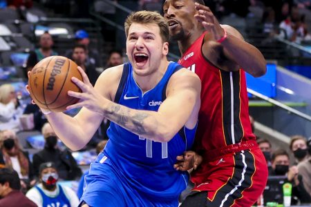 Dallas Mavericks guard Luka Doncic drives to the basket and scores past Miami Heat center Bam Adebayo