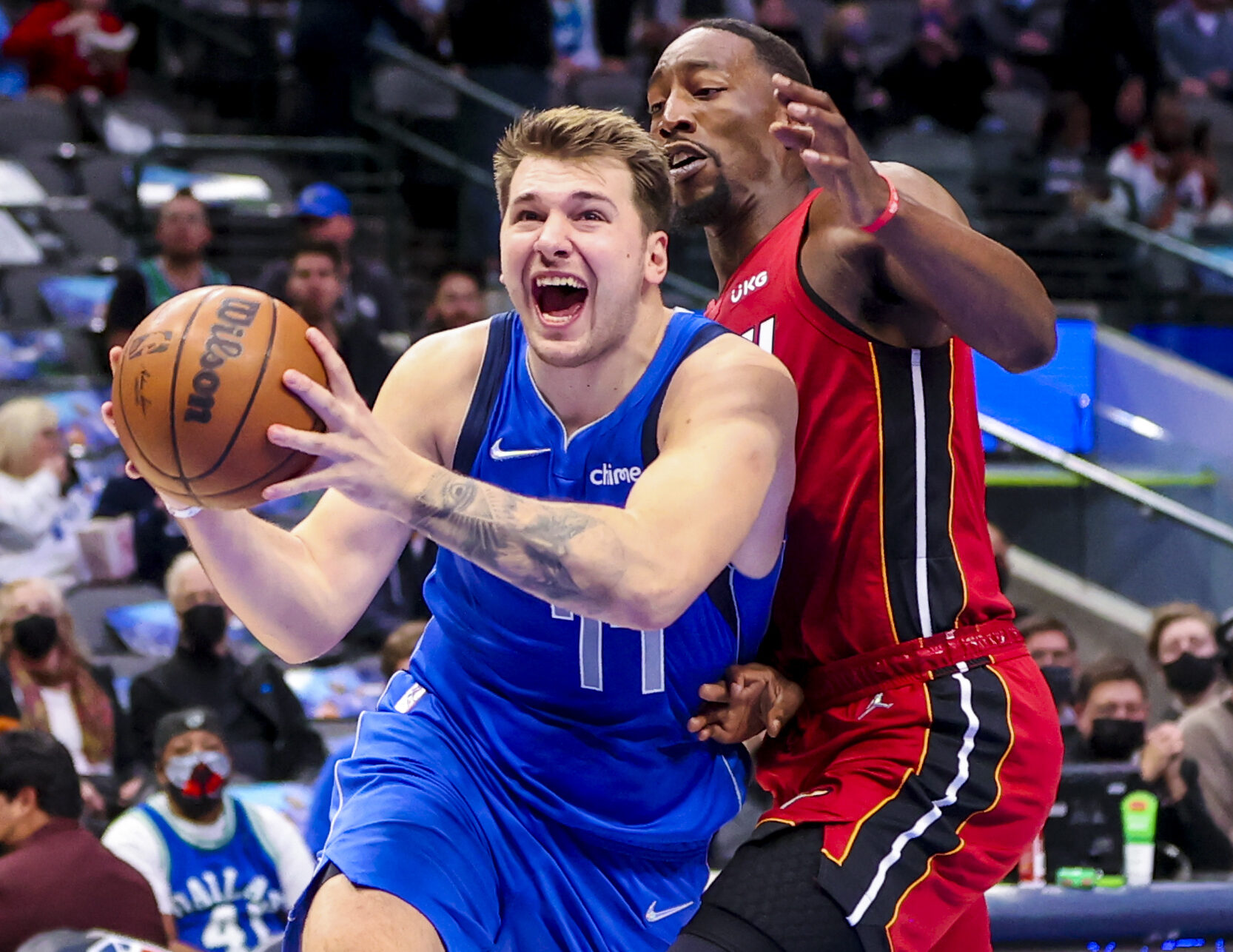 Dallas Mavericks guard Luka Doncic drives to the basket and scores past Miami Heat center Bam Adebayo