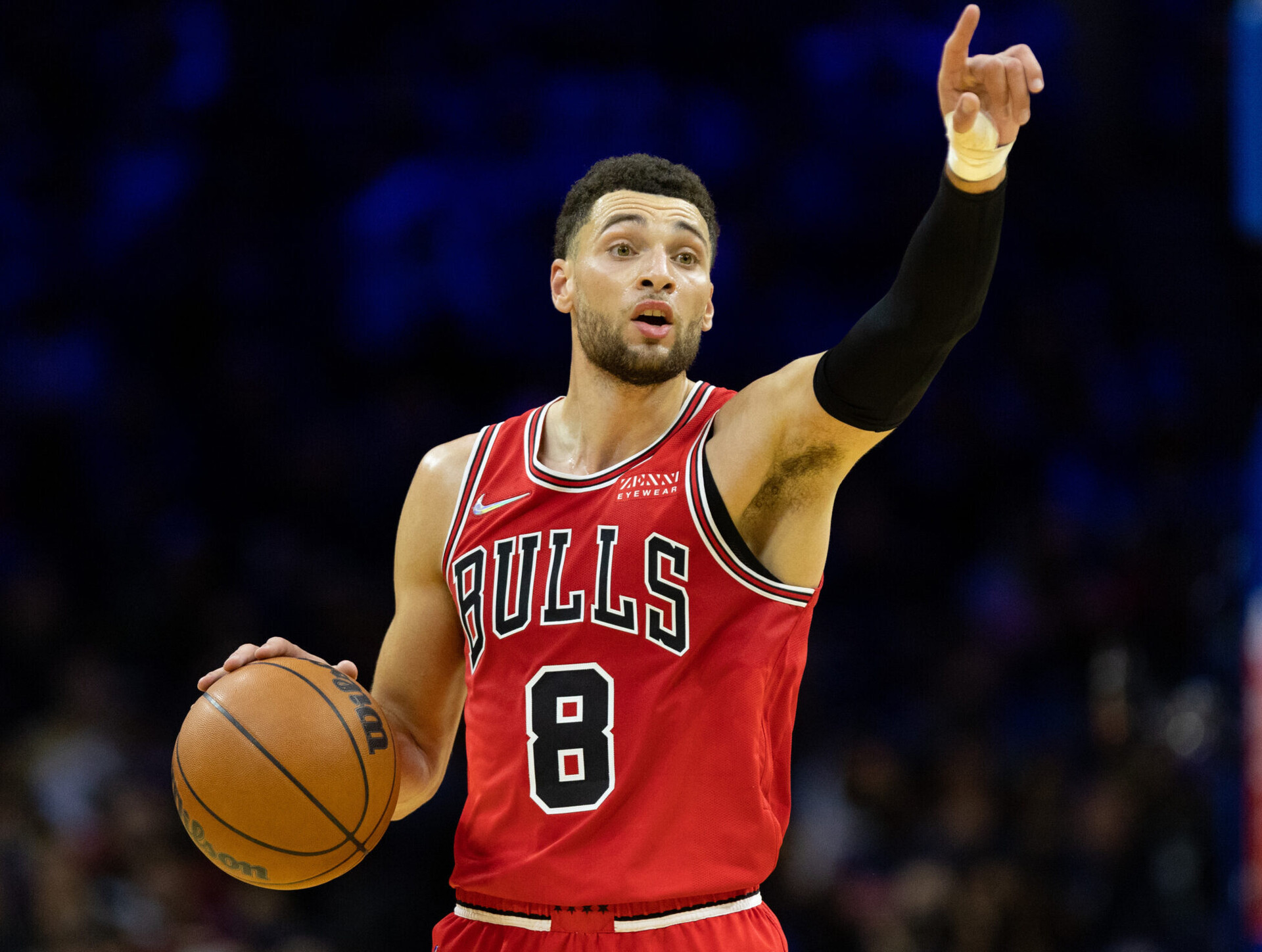 Chicago Bulls guard Zach LaVine gestures to teammates with his left hand while dribbling the ball with his right hand during a game against the Philadelphia 76ers