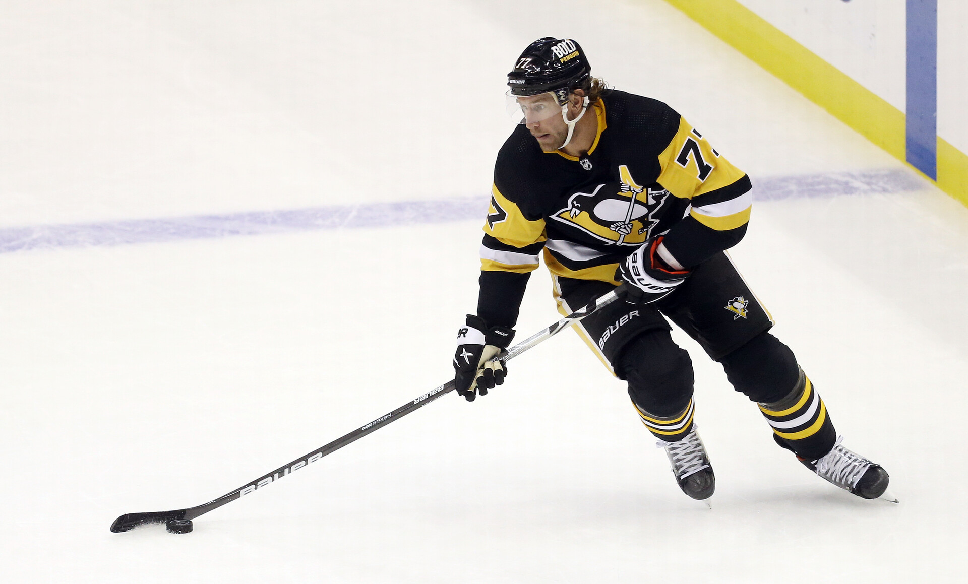 Pittsburgh Penguins center Jeff Carter (77) skates with the puck against the New Jersey Devils during the second period at PPG Paints Arena.