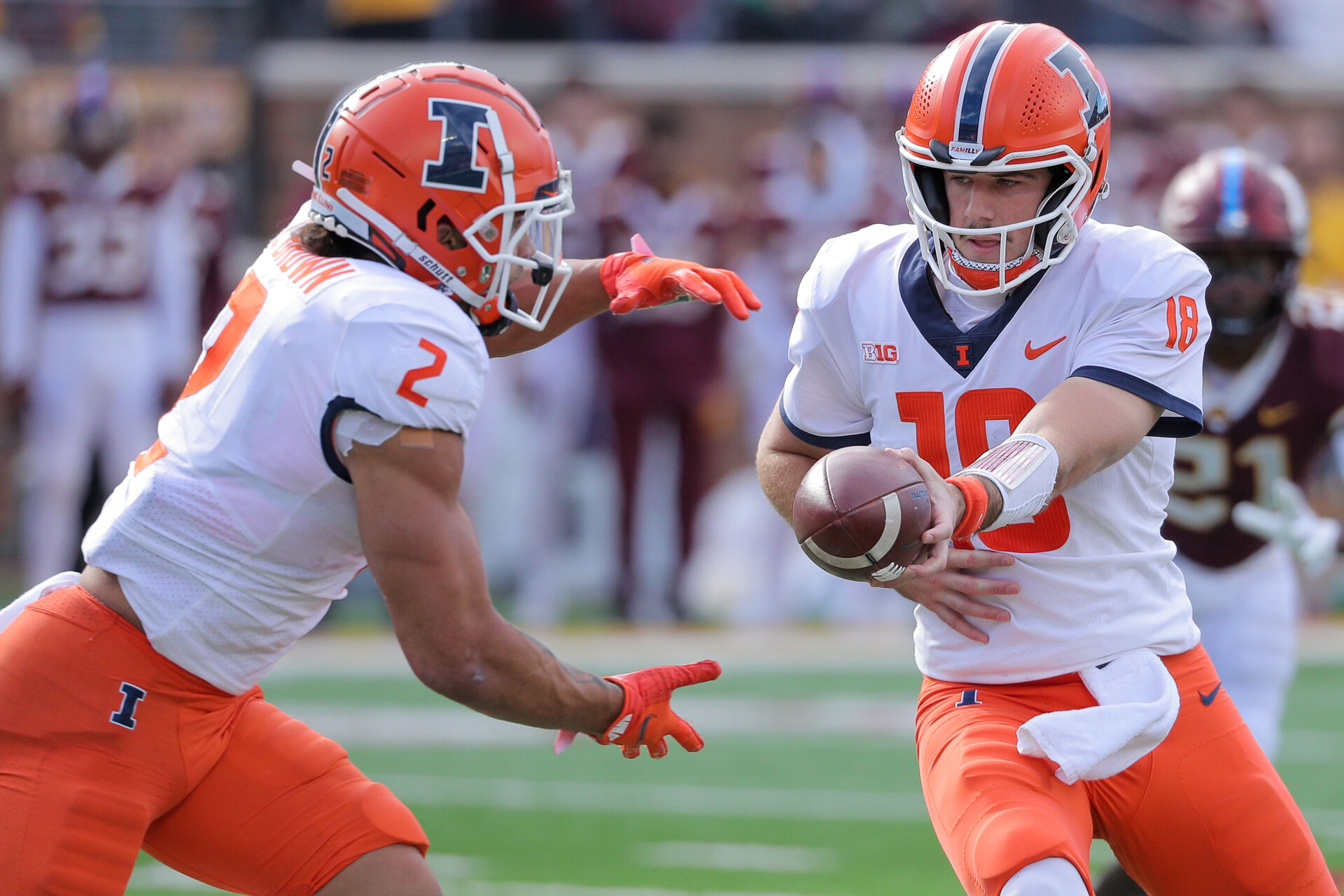 Illinois quarterback Brandon Peters (right) hands the ball off to running back Chase Brown during a game