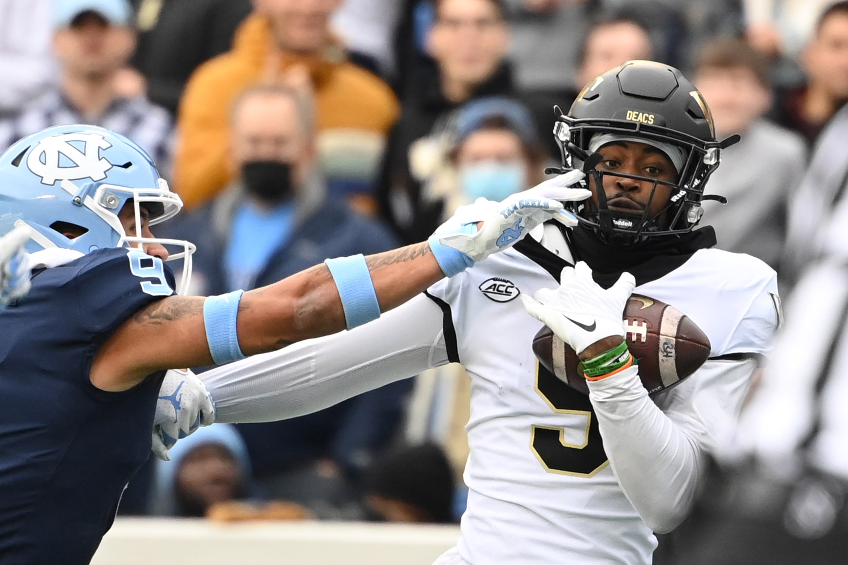 Wake Forest Demon Deacons wide receiver A.T. Perry catches a touchdown pass as North Carolina Tar Heels defensive back Cam'Ron Kelly defends