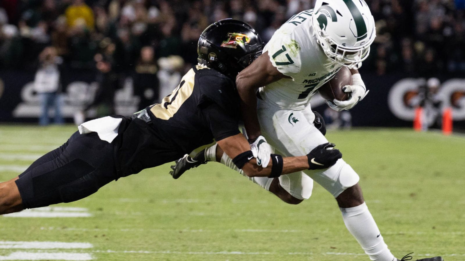 Purdue Boilermakers safety Cam Allen (10) tackles Michigan State Spartans wide receiver Tre Mosley (17) in a game