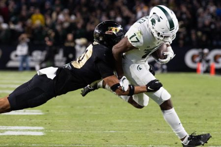 Purdue Boilermakers safety Cam Allen (10) tackles Michigan State Spartans wide receiver Tre Mosley (17) in a game