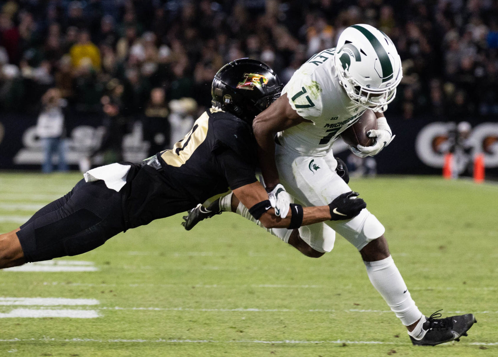 Purdue Boilermakers safety Cam Allen (10) tackles Michigan State Spartans wide receiver Tre Mosley (17) in a game