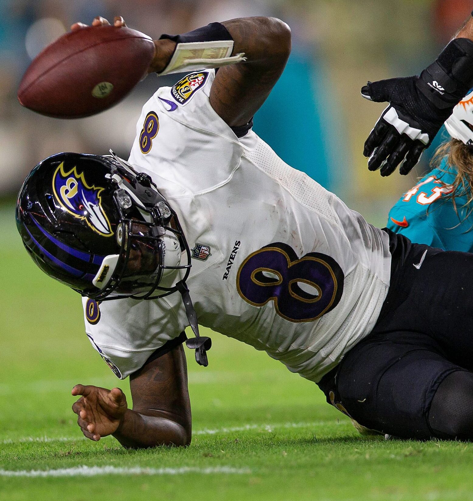 Baltimore Ravens quarterback Lamar Jackson (8), slams the ball after been sacked by Miami Dolphins outside linebacker Andrew Van Ginkel (43), late in the first quarter of their NFL game at Hard Rock Stadium Thursday in Miami Gardens.