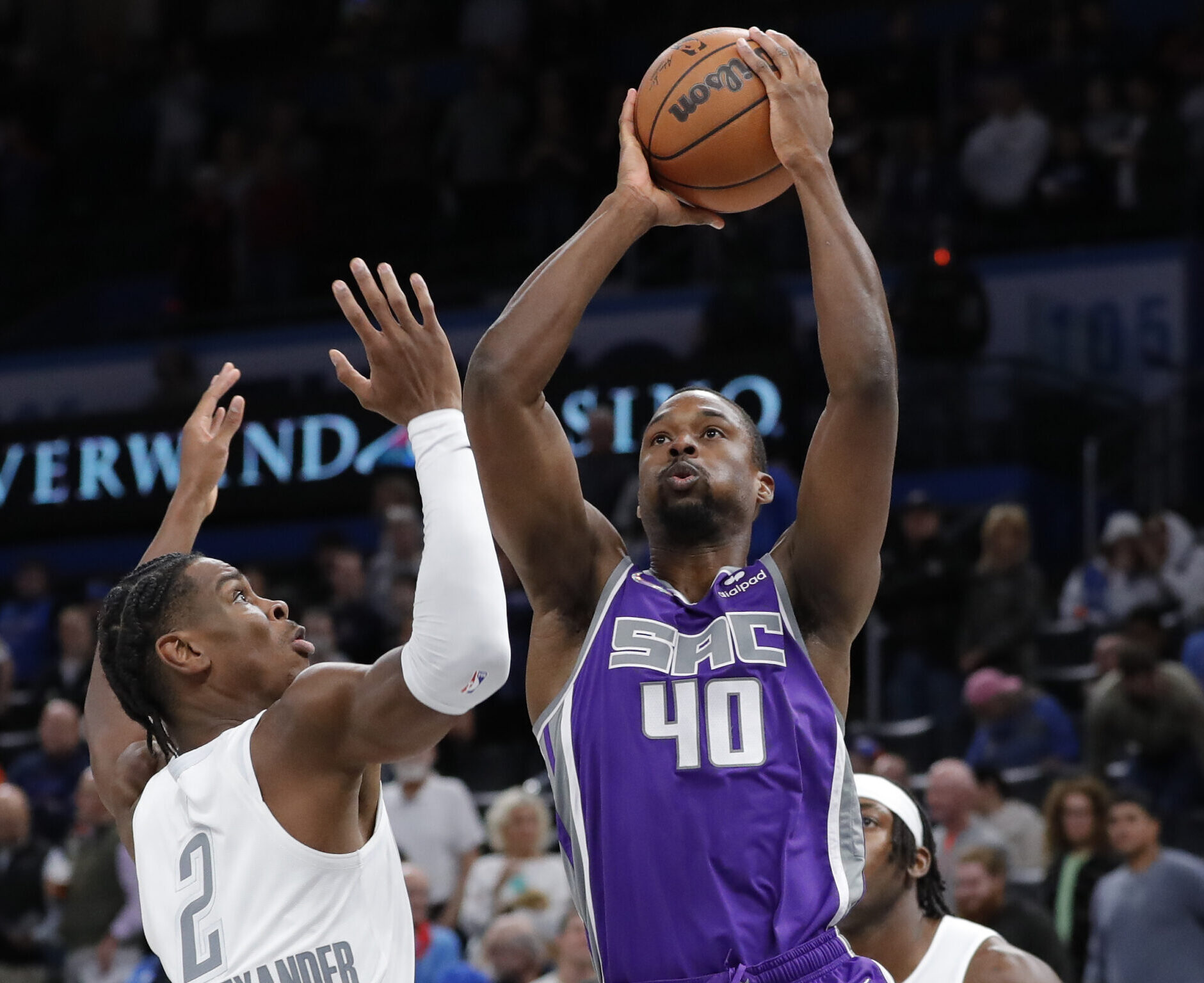 Sacramento Kings forward Harrison Barnes (right) shoots as Oklahoma City Thunder guard Shai Gilgeous-Alexander (left) defends during a game