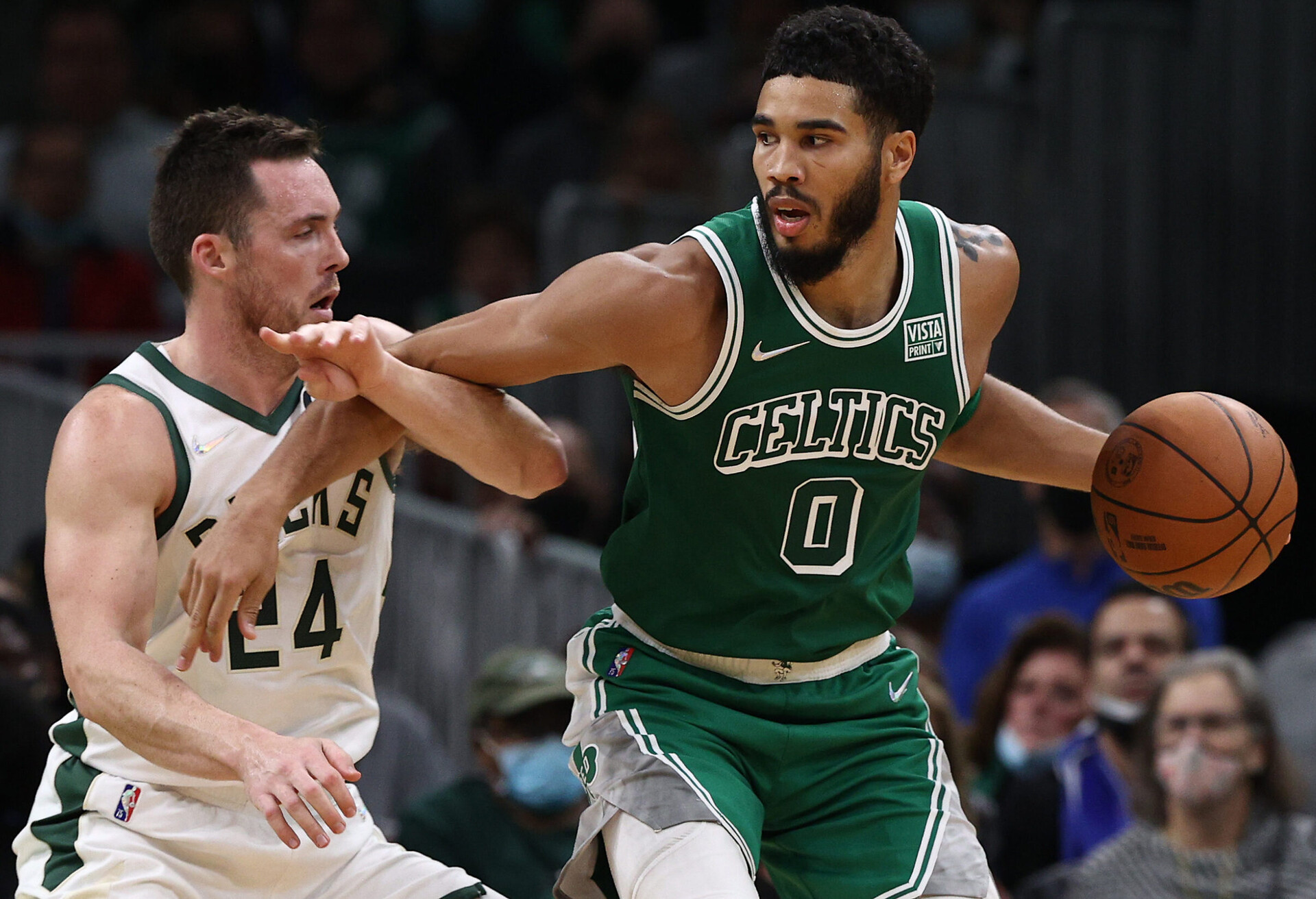 Boston Celtics forward Jayson Tatum (0) looks to get around Milwaukee Bucks guard Pat Connaughton (24)