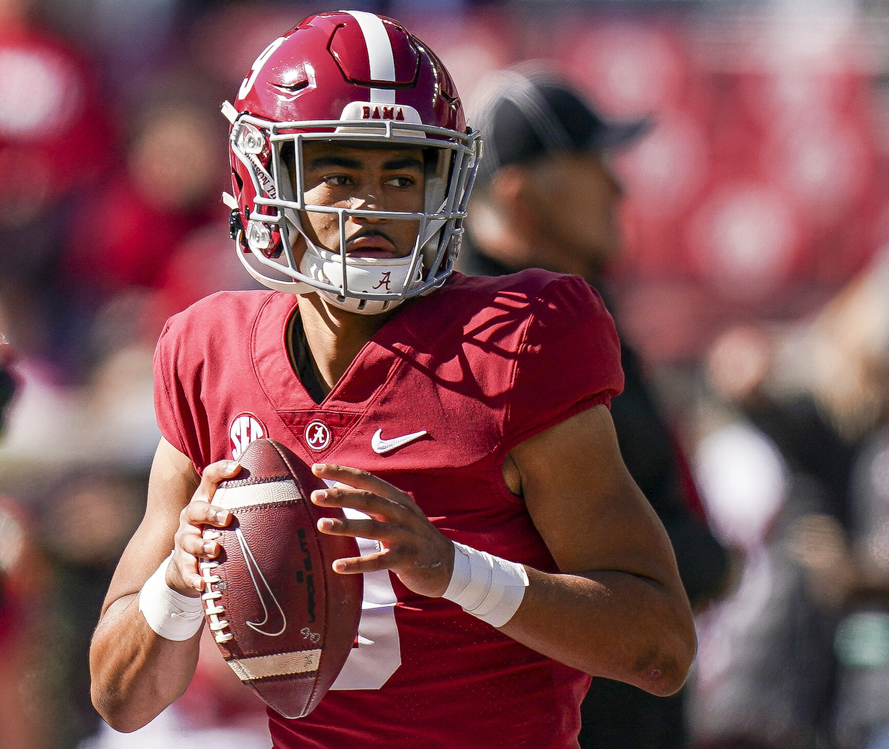 Alabama Crimson Tide quarterback Bryce Young looks downfield before throwing a pass in a game against New Mexico State