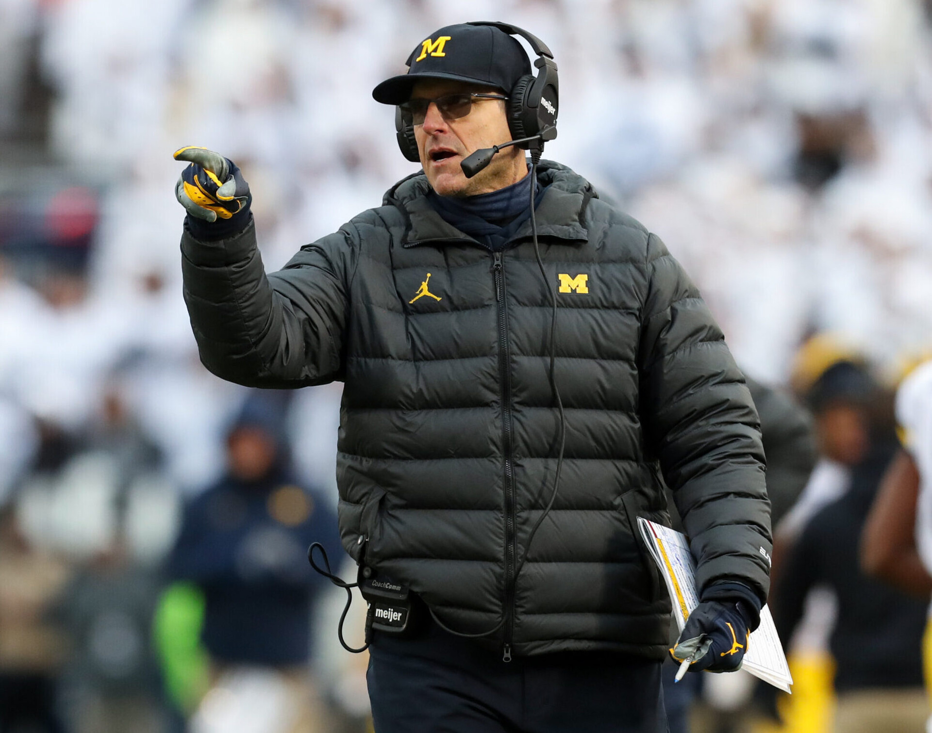 Michigan Wolverines head coach Jim Harbaugh gestures from the sideline against the Penn State Nittany Lions at Beaver Stadium. Michigan defeated Penn State 21-17.