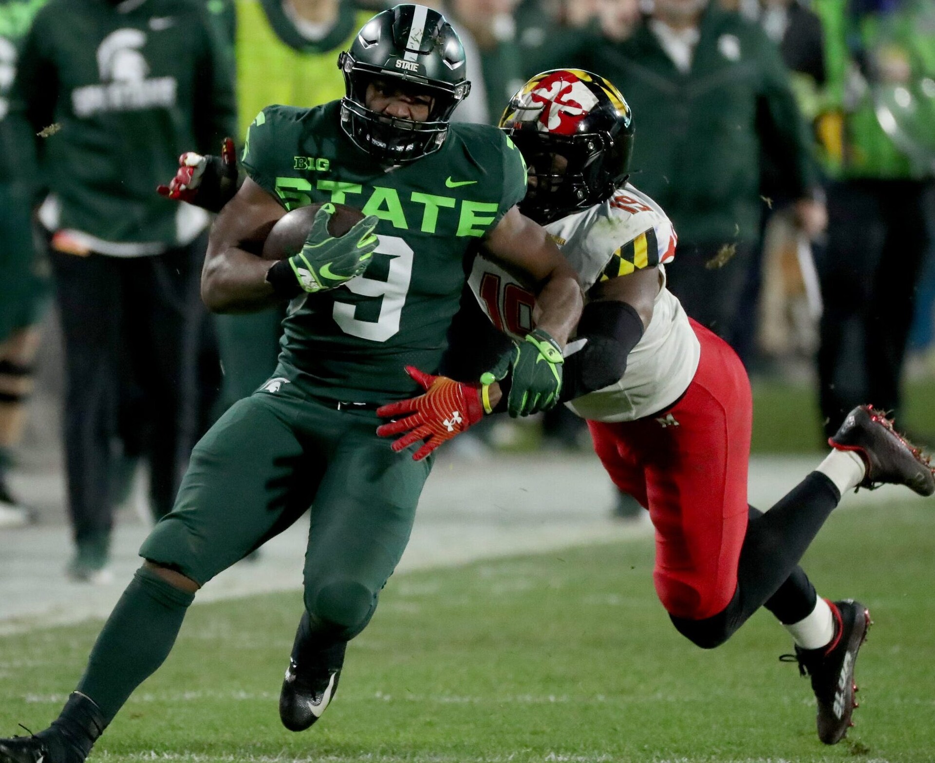 Michigan State Spartans running back Kenneth Walker III runs by Maryland Terrapins linebacker Ahmad McCullough during a game