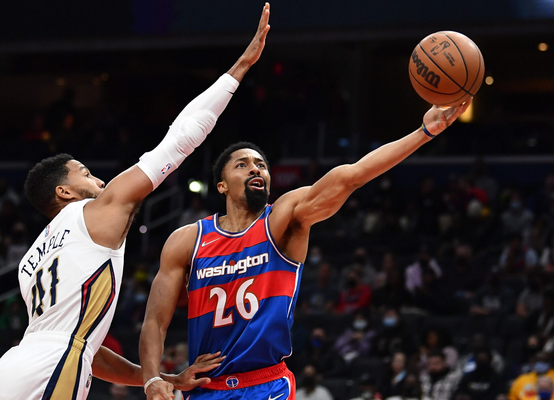 Washington Wizards guard Spencer Dinwiddie (right) shoots the basketball as New Orleans Pelicans forward Garrett Temple (left) defends