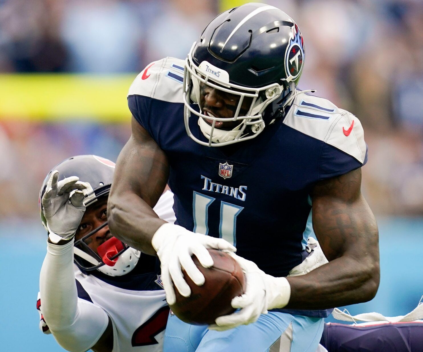 Tennessee Titans wide receiver A.J. Brown (11) pulls in a catch under pressure from Houston Texans cornerback Terrance Mitchell (39) during the first quarter at Nissan Stadium Sunday, Nov. 21, 2021 in Nashville, Tenn.