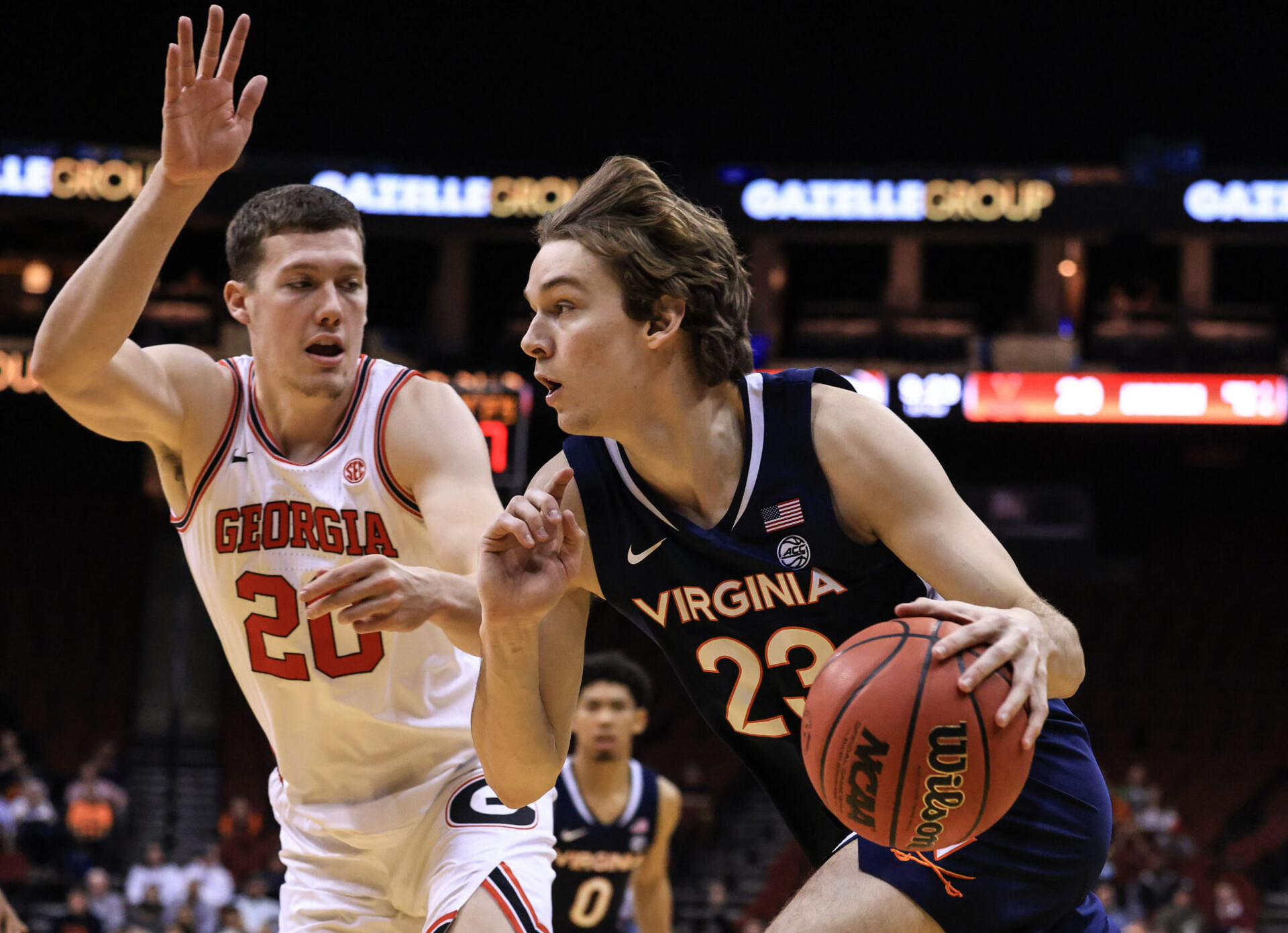 Virginia Cavaliers guard Kody Stattmann (right) drives to the basket as Georgia Bulldogs guard Noah Baumann (left) defends