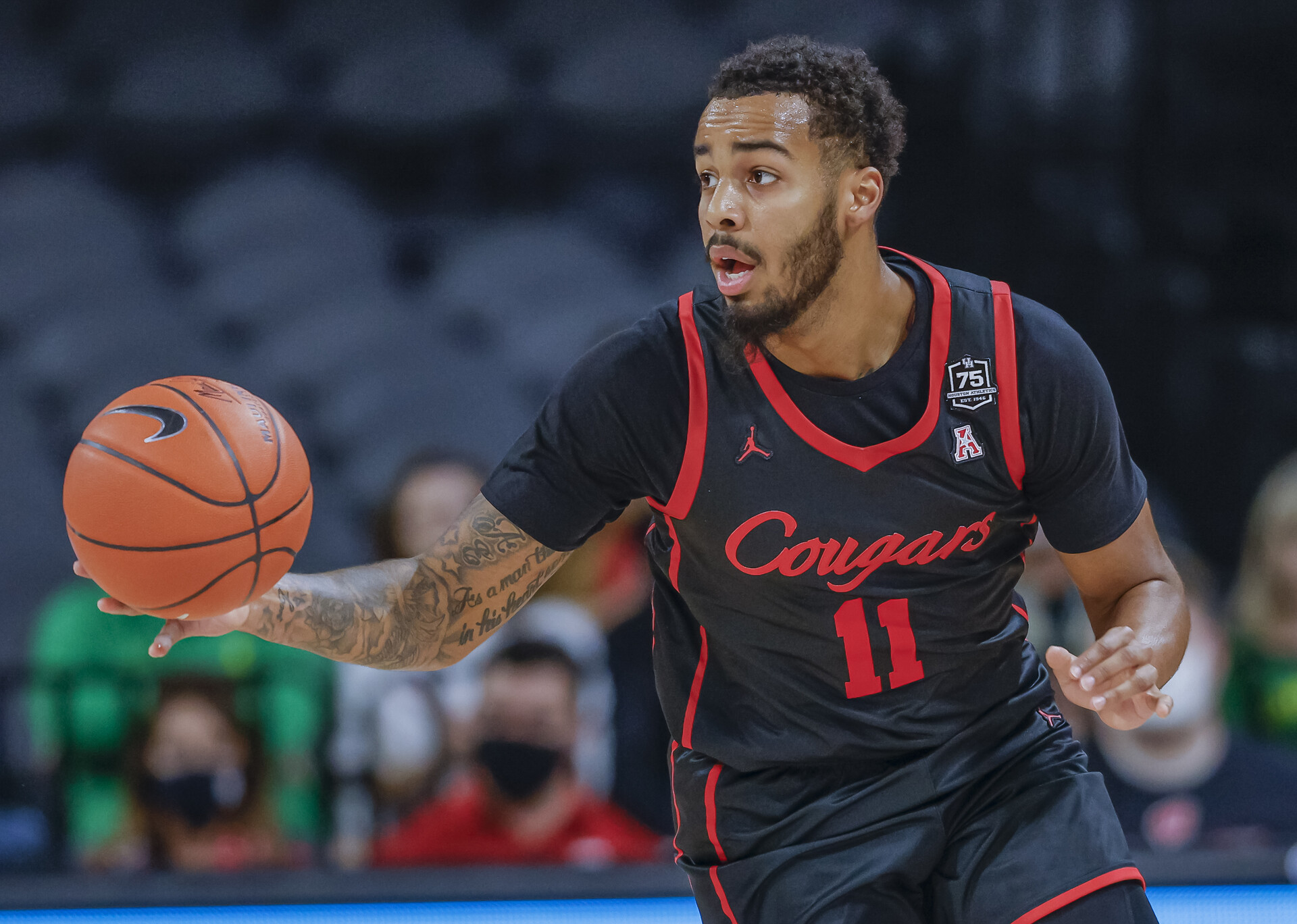 Kyler Edwards #11 of the Houston Cougars brings the ball up court during the game against the Oregon Ducks at Michelob ULTRA Arena on November 24, 2021 in Las Vegas, Nevada.