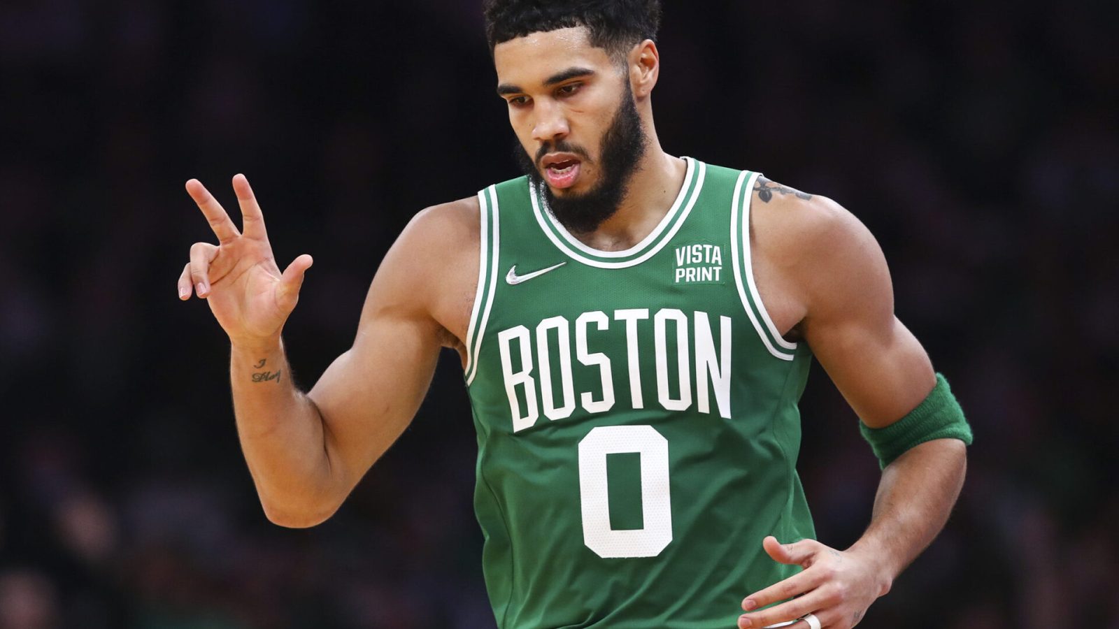 Jayson Tatum #0 of the Boston Celtics reacts after hitting a three-point shot during a game against the Milwaukee Bucks at TD Garden on December 13, 2021 in Boston, Massachusetts.
