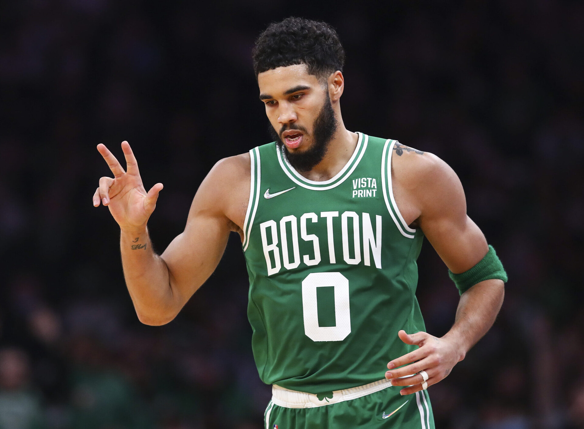 Jayson Tatum #0 of the Boston Celtics reacts after hitting a three-point shot during a game against the Milwaukee Bucks at TD Garden on December 13, 2021 in Boston, Massachusetts.