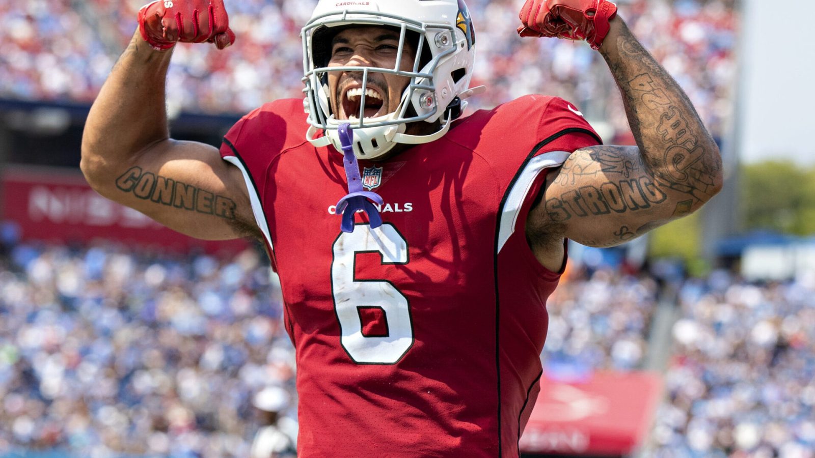 James Conner #6 celebrates with DeAndre Hopkins #10 of the Arizona Cardinals after a touchdown during the game against the Tennessee Titans at Nissan Stadium on September 12, 2021 in Nashville, Tennessee.