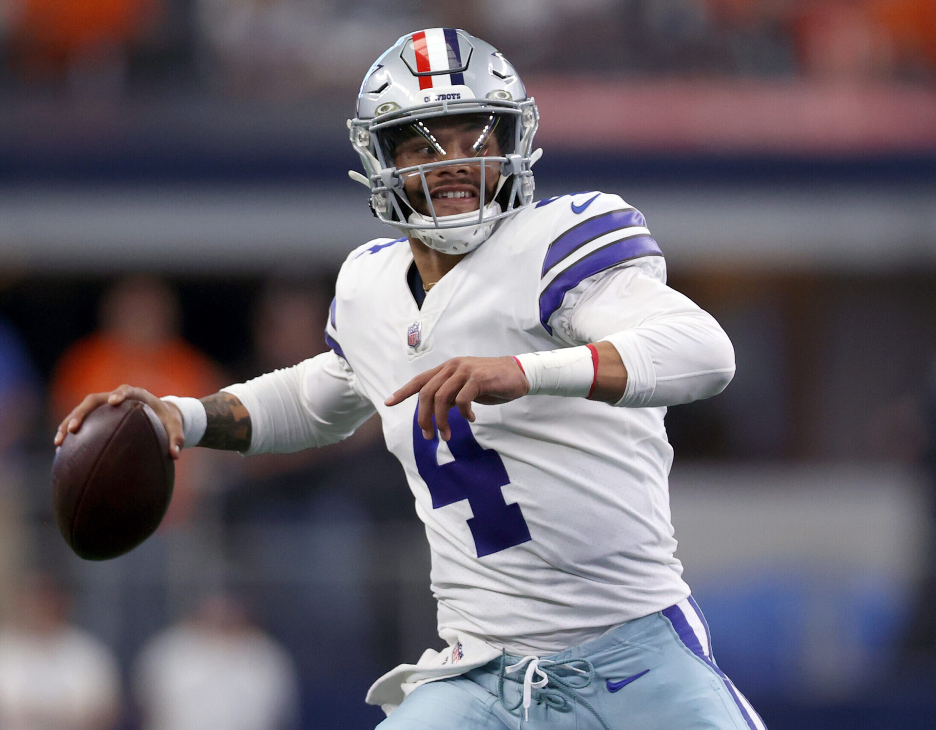 Dak Prescott #4 of the Dallas Cowboys scrambles with the ball during the first quarter against the Denver Broncos at AT&T Stadium on November 07, 2021 in Arlington, Texas