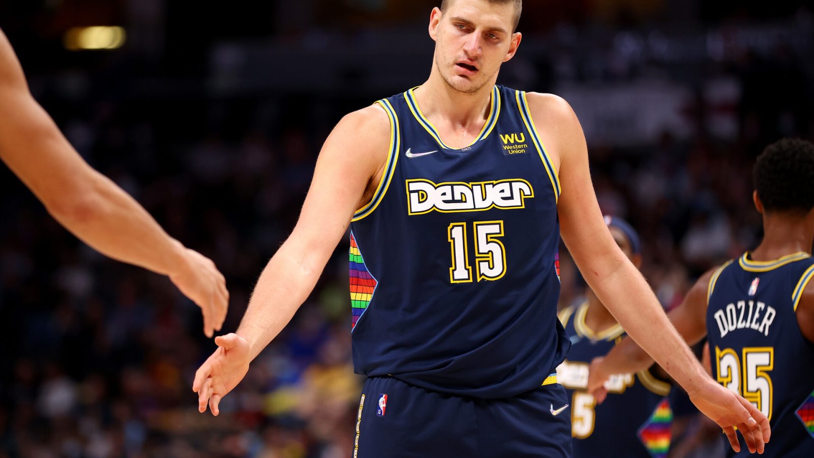 Nikola Jokic #15 of the Denver Nuggets gives high fives against the Houston Rockets at Ball Arena on November 6, 2021 in Denver, Colorado.
