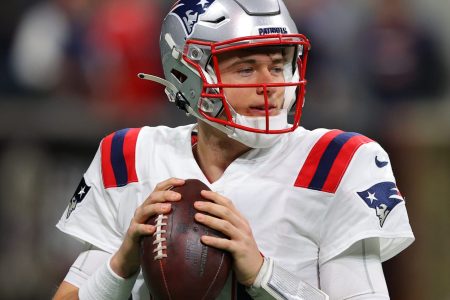 Mac Jones #10 of the New England Patriots warms up prior to playing the Atlanta Falcons at Mercedes-Benz Stadium on November 18, 2021 in Atlanta, Georgia.