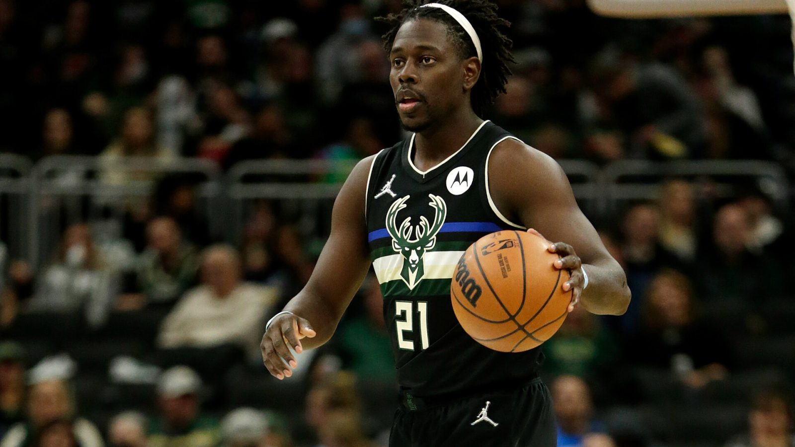 Jrue Holiday #21 of the Milwaukee Bucks dribbles the basketball up court during the first half of the game against the Oklahoma City Thunder at Fiserv Forum on November 19, 2021 in Milwaukee, Wisconsin. Bucks defeated the Thunder 96-89.