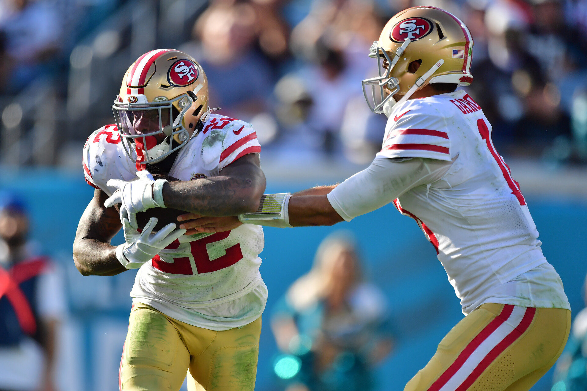 Jimmy Garoppolo #10 of the San Francisco 49ers hands the ball to Jeff Wilson Jr. #22 during the fourth quarter against the Jacksonville Jaguars at TIAA Bank Field on November 21, 2021 in Jacksonville, Florida.