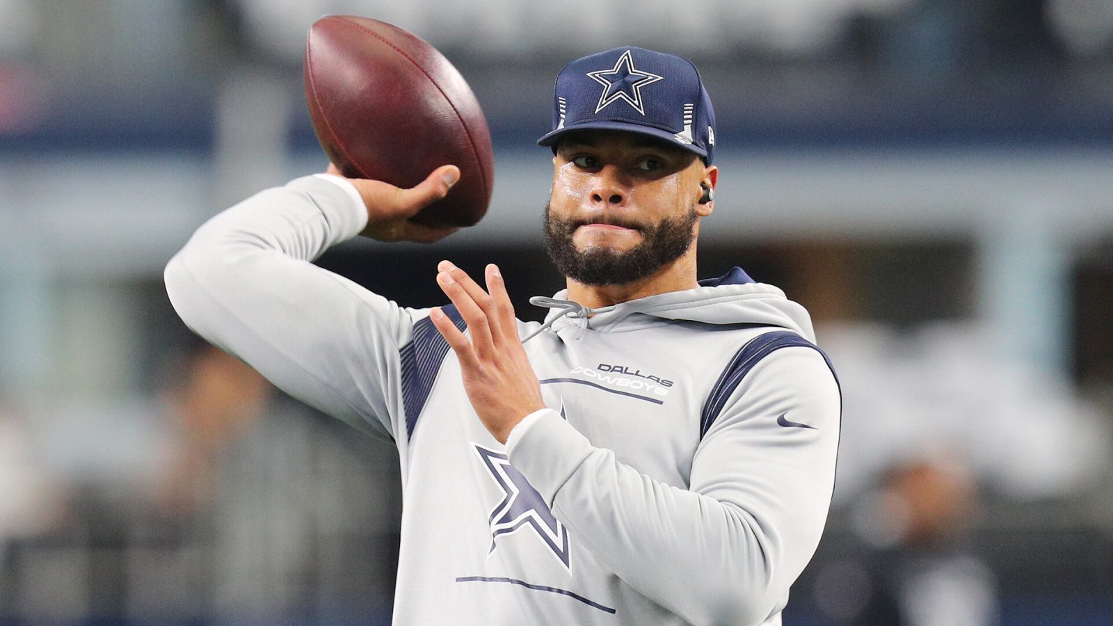 Dak Prescott #4 of the Dallas Cowboys warms up ahead of the NFL game between Las Vegas Raiders and Dallas Cowboys at AT&T Stadium on November 25, 2021 in Arlington, Texas.