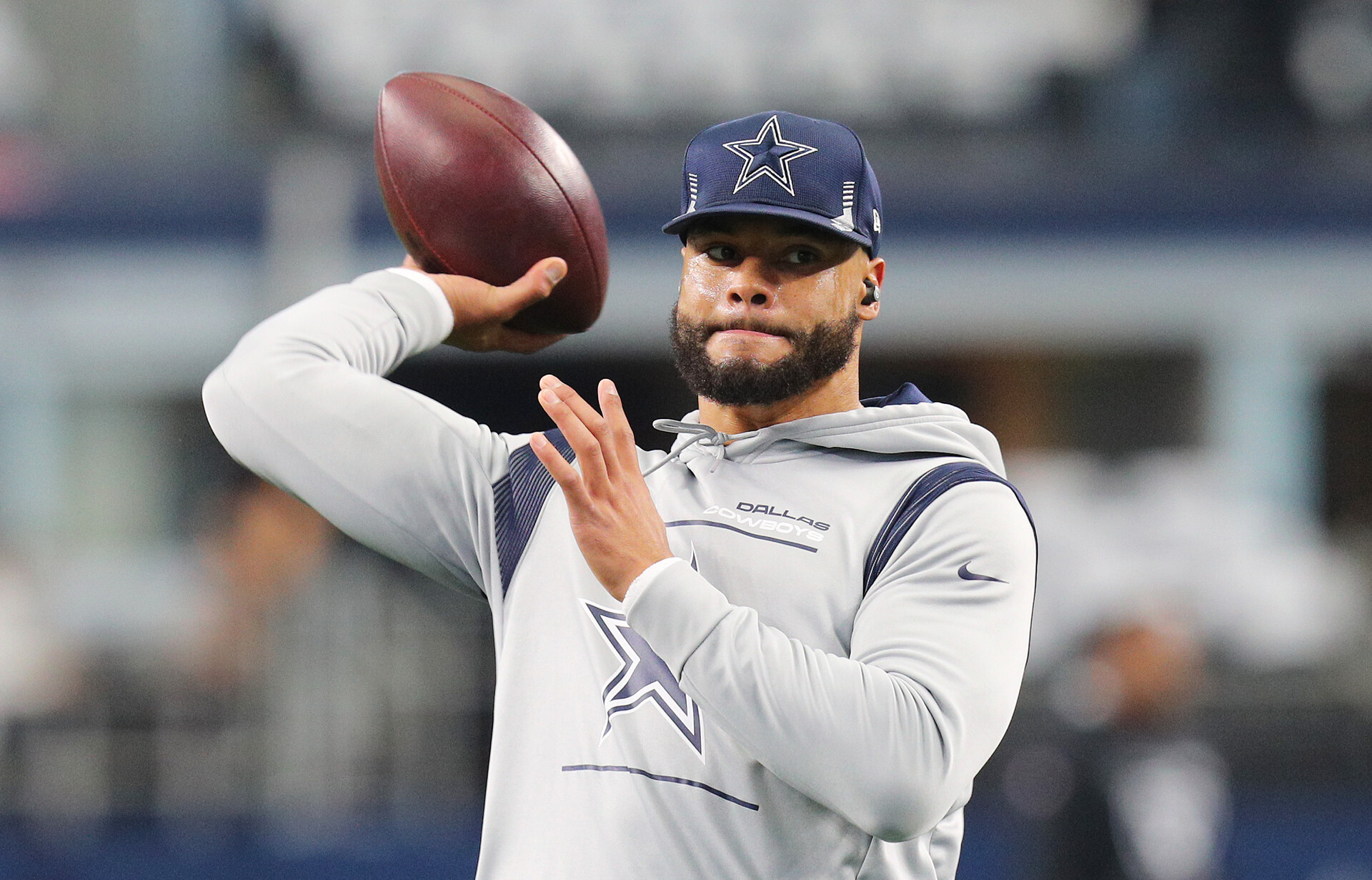 Dak Prescott #4 of the Dallas Cowboys warms up ahead of the NFL game between Las Vegas Raiders and Dallas Cowboys at AT&T Stadium on November 25, 2021 in Arlington, Texas.